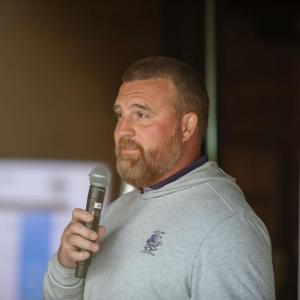 Someone speaking into a microphone