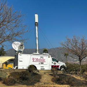 A T-Mobile vehicle with a satellite equipment near trees