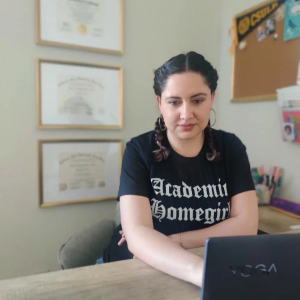 Dr. Maricela Becerra, using a laptop