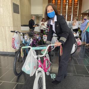 pilot posing with children's bike
