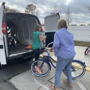 woman loading bike into van