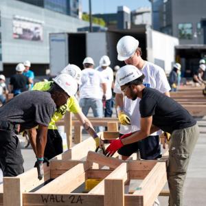 AEG employees helped build wall frames for for future homes in Altadena.