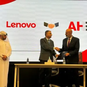 People shaking hands while another looks on