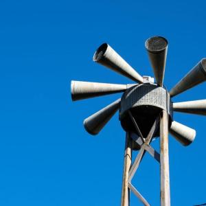 Civil defense sirens under a blue sky