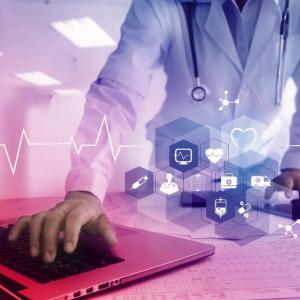A medical professional using a laptop. Medical symbols overlaid.