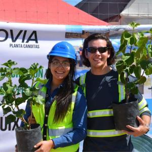 Abel and another posed with tree saplings.
