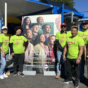 Photo of MilliporeSigma volunteers stand in from of an "Abbott Elementary" sign