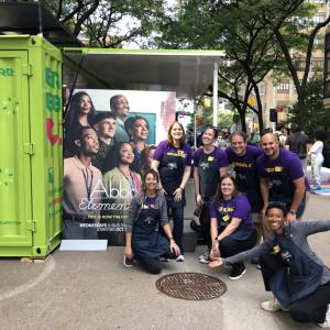 Photo of MilliporeSigma volunteers stand in from of an "Abbott Elementary" sign