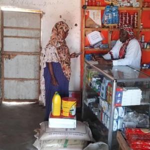 Abshiro purchases food with cash assistance support from Action Against Hunger, funded by EU Humanitarian Aid.
