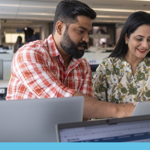 Two people looking at a computer together