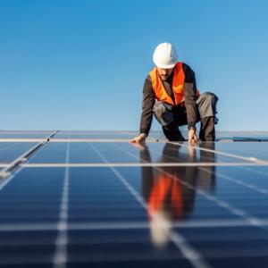Worker installing solar panels