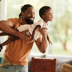 An adult carrying a young child 