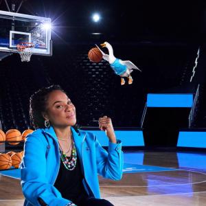 Dawn Staley and the Aflac Duck shown slam dunking a basketball.