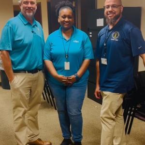 Aflac volunteers shown with representatives from the Chattahoochee Valley school district.