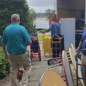 Donated furniture for the school system is being loaded into a truck.