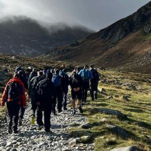 Aflac Northern Ireland volunteers on the Three Peaks Challenge, a trek to the Mournes that includes Slieve Binnian, Slieve Commedagh and, finally, an ascent to the top of Slieve Donard.