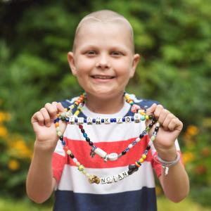 Young girl holding the beads of color.