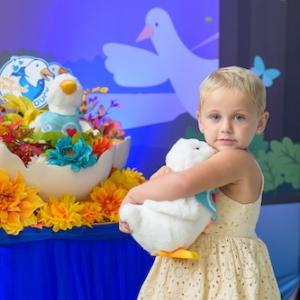 Young girl clutching her duck.