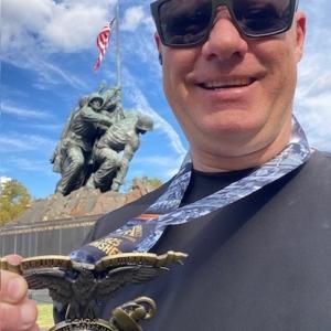 Michael showing off his medal from the Marine Corps marathon.