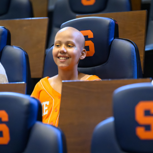 Judy shown seated at the Syracuse game.
