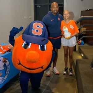 Judy with Syracuse Head Football Coach Fran Brown and the Syracuse mascot.
