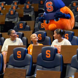 Judy in the stands with the Syracuse mascot.