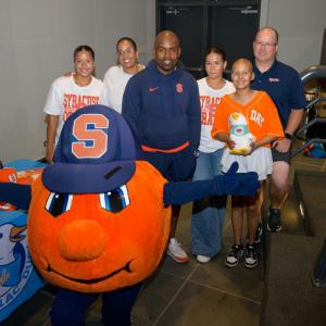 Judy with her family and Syracuse Head Football Coach Fran Brown.