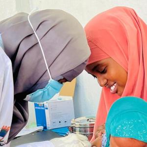 Aisho takes her daughter to the Action Against Hunger-supported clinic in Kismayo for a measles vaccine. 