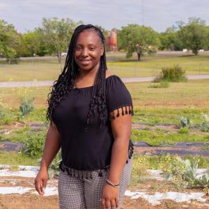 Photo of a person stood in a field looking into the camera