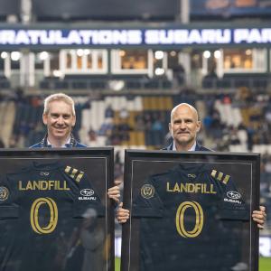 Alan Bethke, Subaru of America Inc.’s Senior Vice President - Marketing, and Tim McDermott Philadelphia Union’s President, celebrate Subaru Park becoming the first soccer stadium in Major League Soccer to achieve zero landfill status on October 23, 2021.  