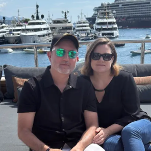 Alejandro with his wife at a marina.