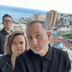 Alejandro with his wife and friend on top of a skyscraper.