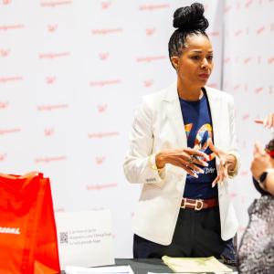 Alethia speaking with another person