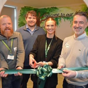 Four people at the library ribbon cutting