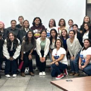 A large group of students and adults in a classroom.