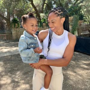Allyson Felix holding her child