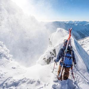 A person stood on top of a snowy mountain
