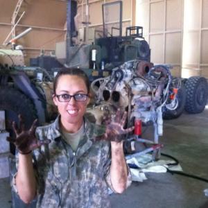 Amber repairing a diesel engine while in military service.