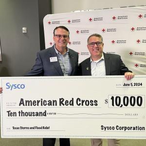 Two people holding a large cheque 