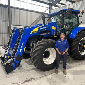 Amy Reid standing by a large tractor.