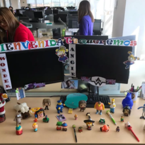 Angie's desk with many figurines and welcome sign