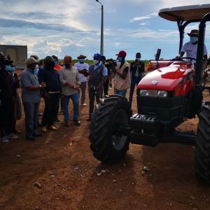 group standing around donated tractor