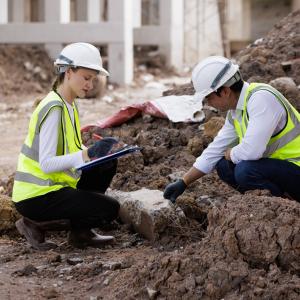Site investigators take notes on foundation sediment 