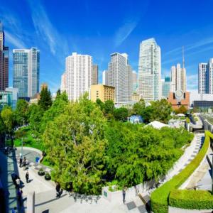 City skyline above a green park