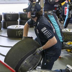 person lifting a tire