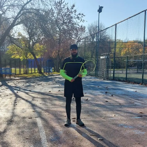 Armand on a tennis court.