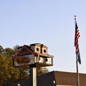 Birdhouse next to American flag