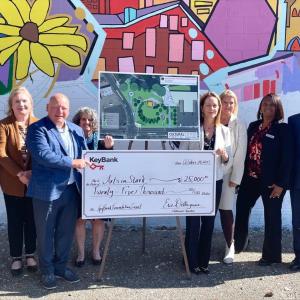 Representatives from ArtsInStark and KeyBank shown with a $25,000 grant check.