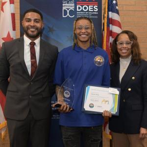 Ashanti Hunt holding an award and certificate 