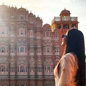 Ashwini Siddhi in front of a palace in India.